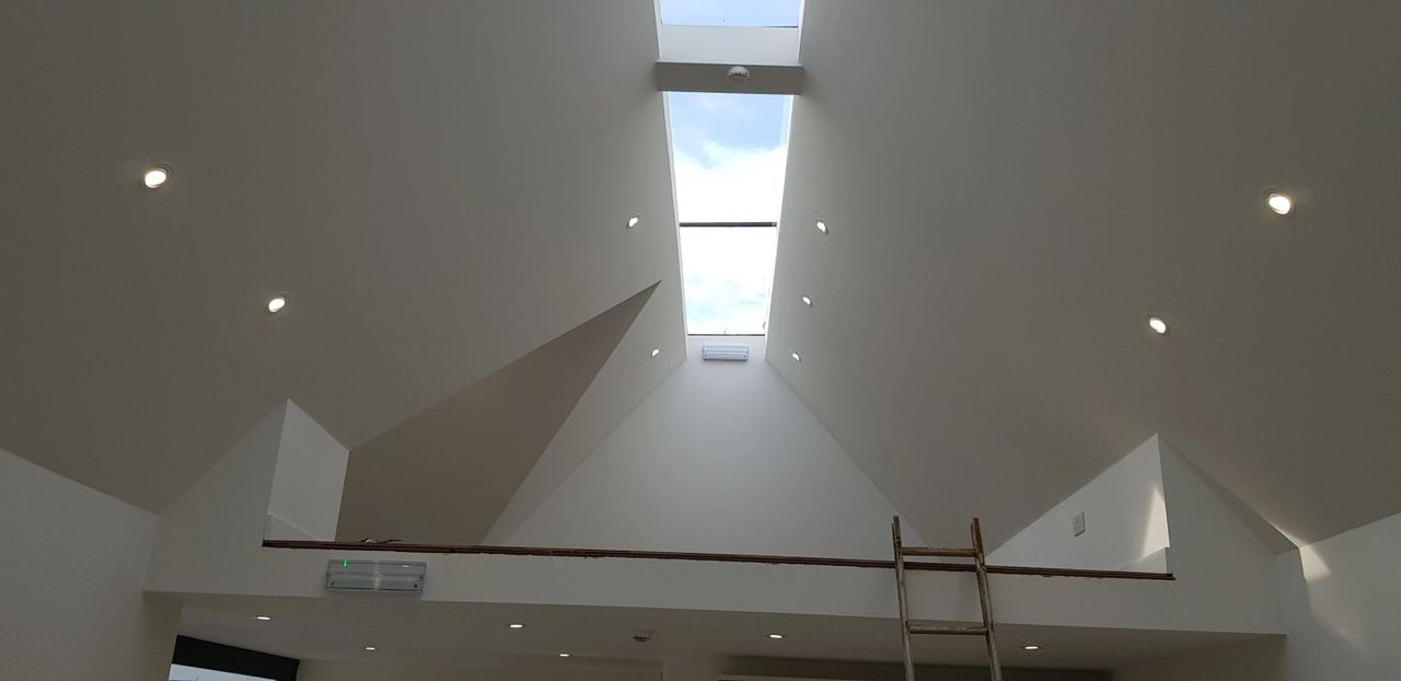 Recessed LED downlights installed in a bright vaulted ceiling
