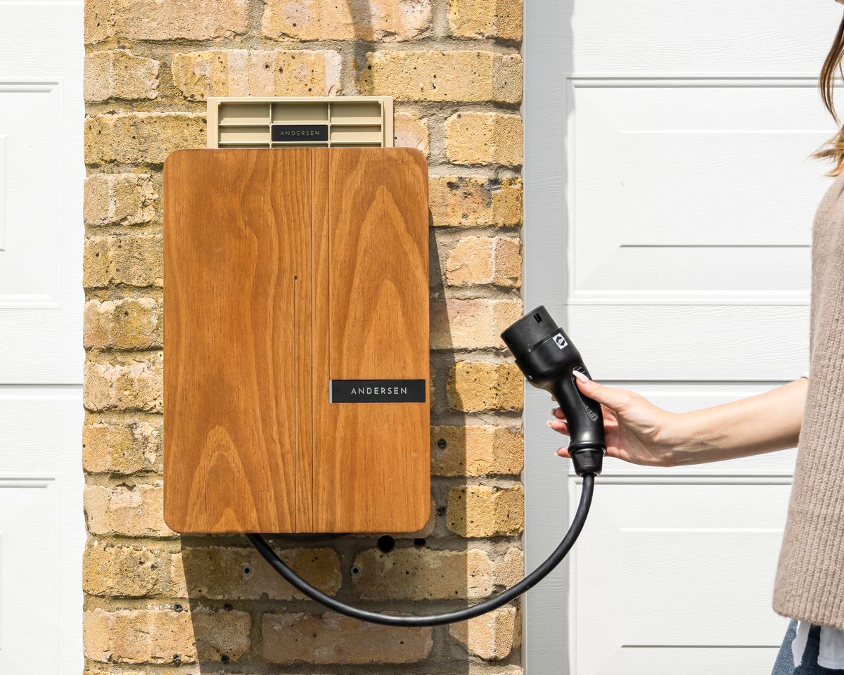 Home EV charger with a Type 2 connector on a brick wall