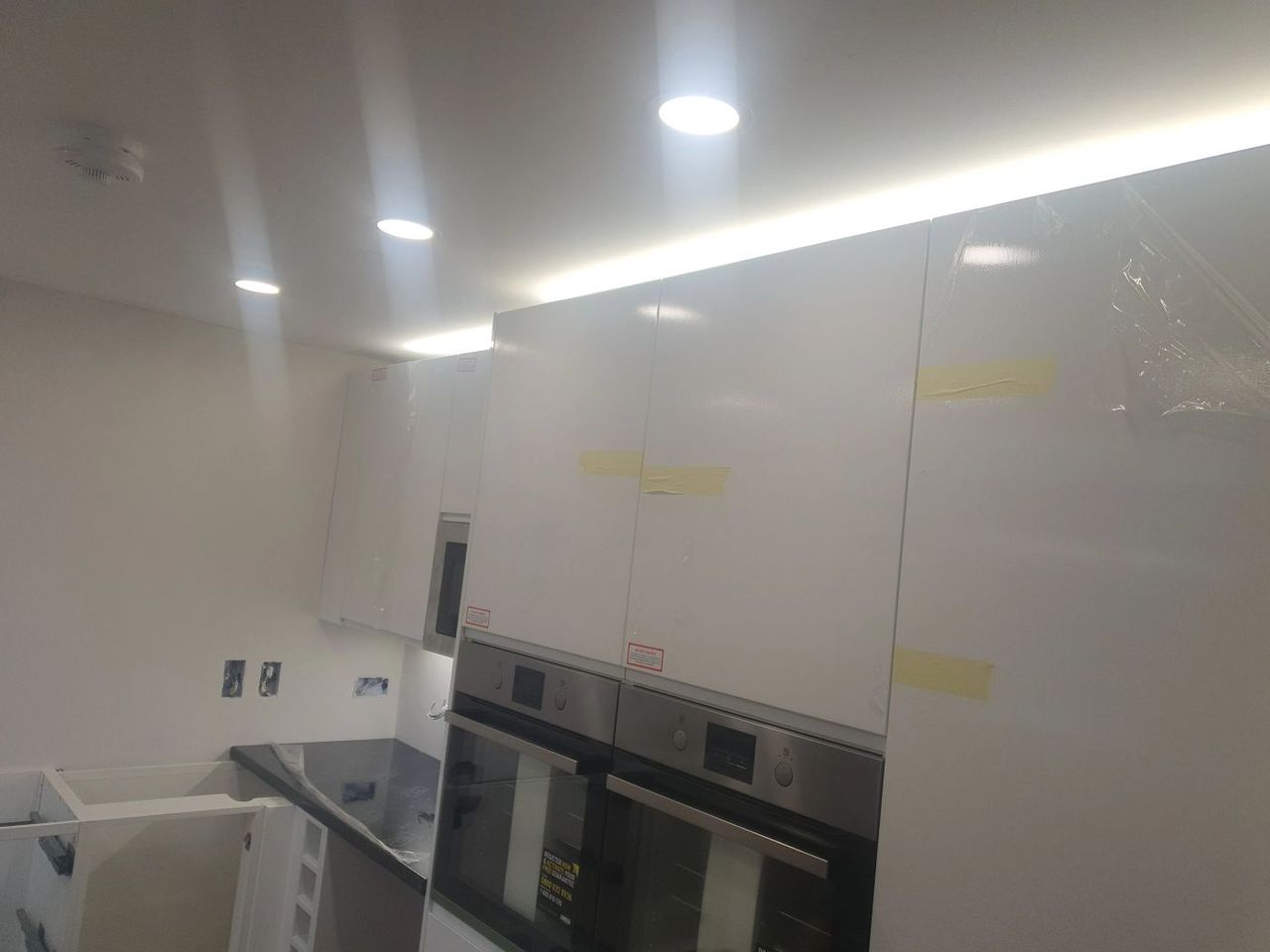 Kitchen with built-in ovens and recessed lighting