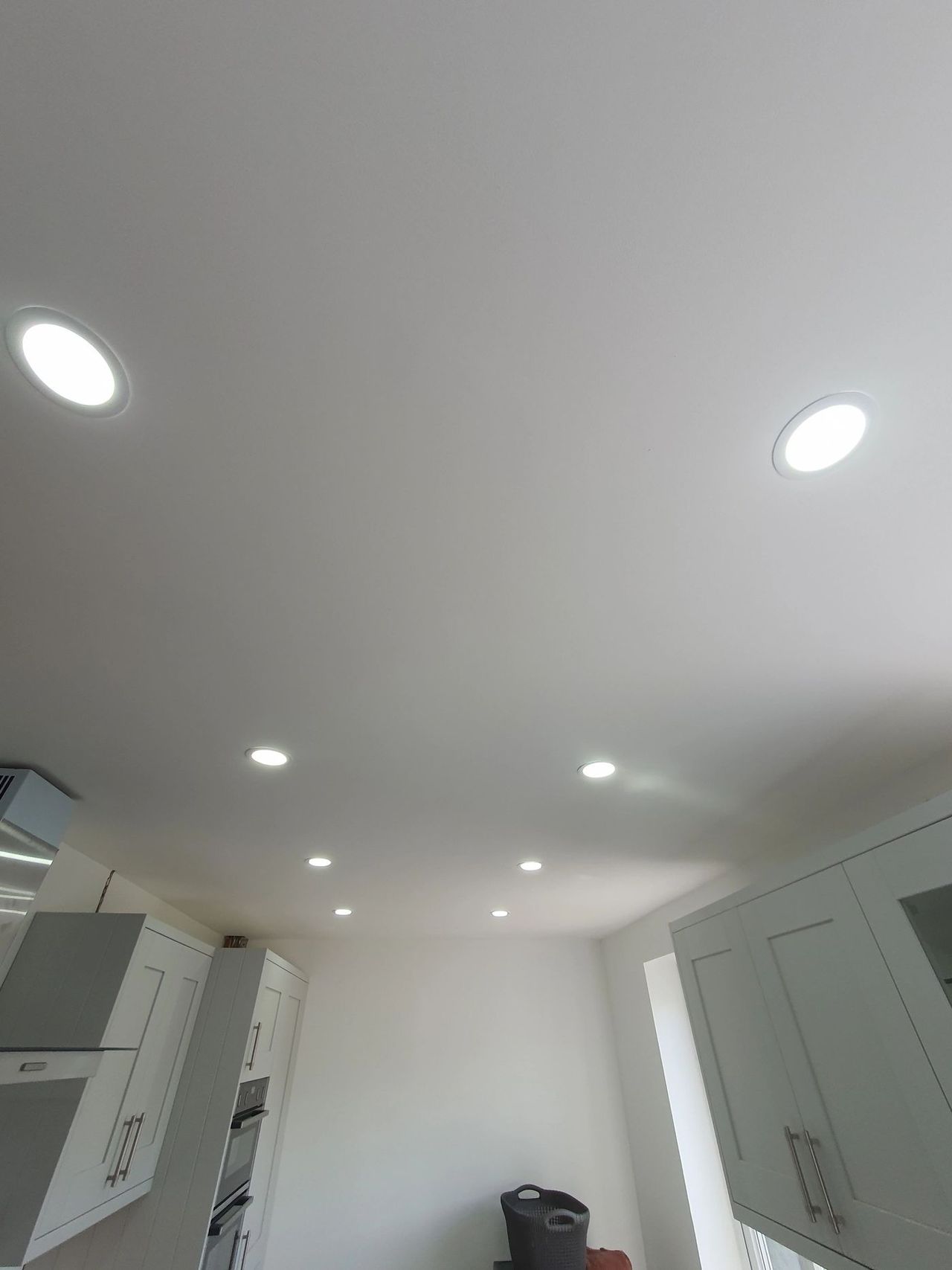 Recessed downlight set into a smooth plastered ceiling
